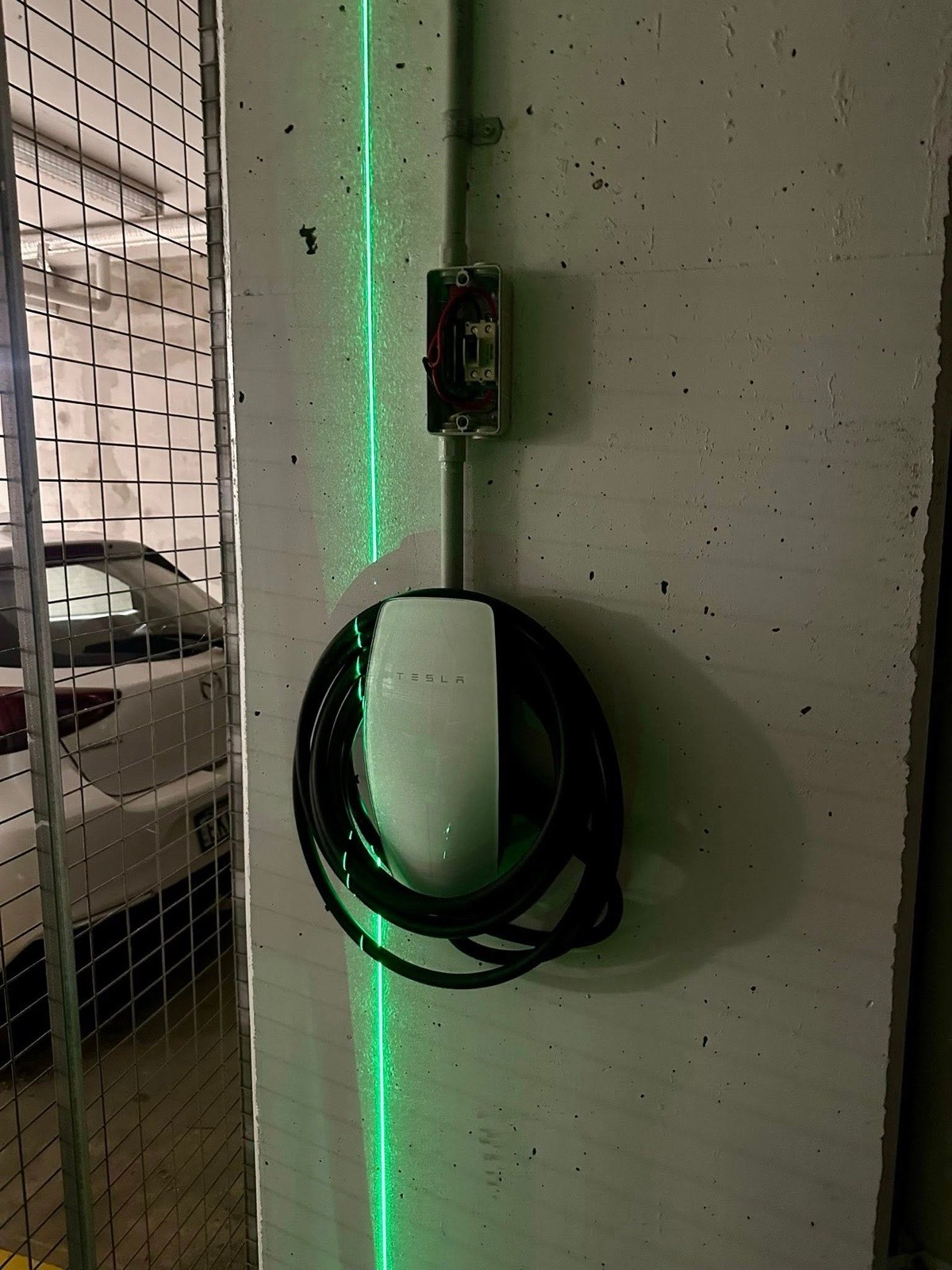 Wall-mounted EV charger installed in a carport