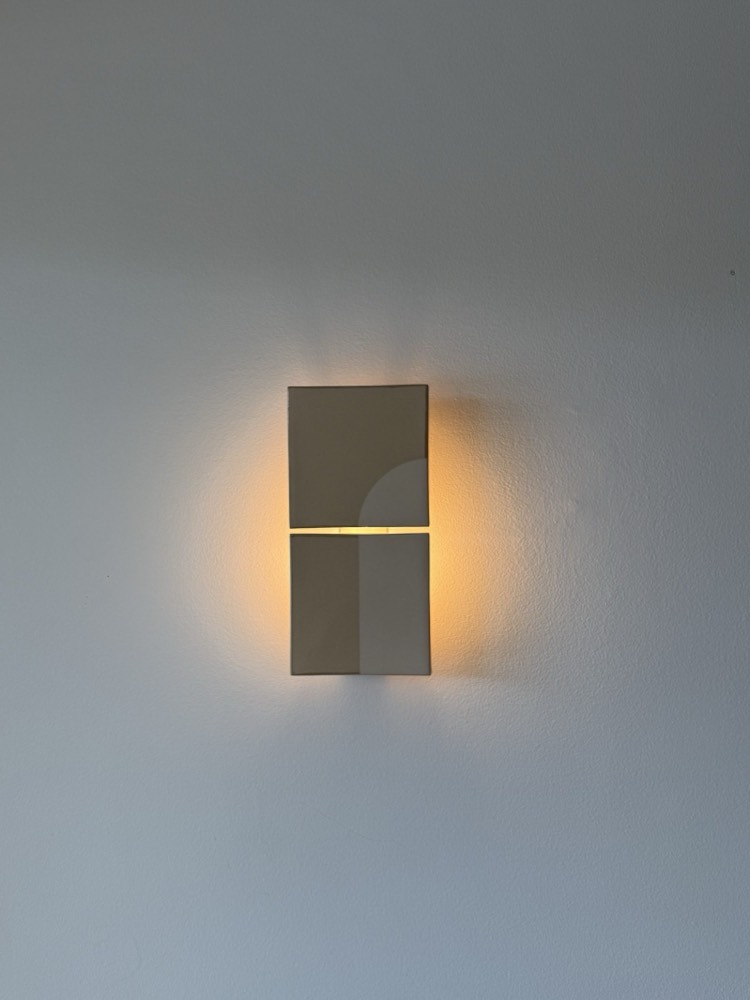 Warm architectural wall sconce installed by Marmont Electrical