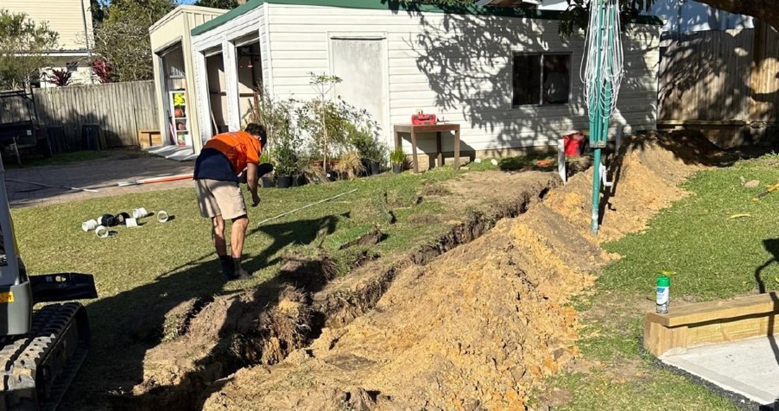 Trench dug across a lawn for an underground electrical cable run